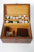 A vintage mahogany cased metamorphic sewing box with accessories set within.