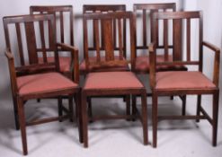 A set of 6 Air Ministry stamped oak dining chairs raised on squared legs.