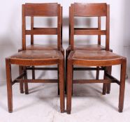 A good early 20th century set of 4 dining chairs having bar back rests over faux tan leather seats