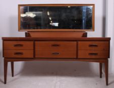 A 1970's angular teak wood dressing table being raised on tapered supports  with mirror above
124 H