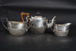 A 19th century Victorian 1893 hallmarked silver teaset comprising of teapot with carved handle and