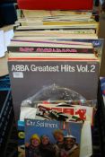 A collection of vinyl record LP's and singles to include The Spinners, Abba, and other artists.