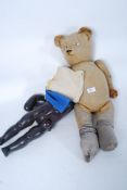 A vintage straw filled teddy bear of large form together with a Pedigree childs doll ( both af )
