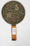 A Japanese bronze / brass hand mirror with crane and calligraphy decoration having rattan weave to