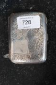 A hallmarked antique silver 1908 cigarette case with detailed chased engraving to front.