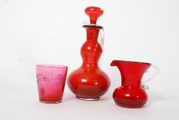 A 19th century red / cranberry glass decanter complete with the stopper together with a cranberry