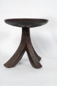 A 20th century 4 leg African tribal stool with carved detailing