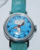 A vintage childs Snoopy wristwatch in blue complete with the original strap ( see illustration )