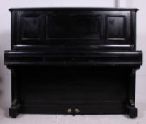 A 20th century upright iron framed Bechstein piano having ivory keys with an ebonised wooden