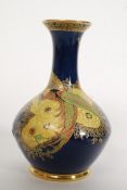 A Carltonware bulbous vase decorated with a bird of paradise standing amongst trees,