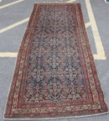 A late 19th century / 20th century hand woven Persian rug having blue and black ground surrounding