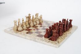 A well carved complete marble chess set and board.