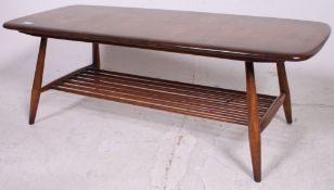An Ercol beech and elm golden dawn rectangular coffee table raised on tapered supports with
