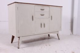 A 1950's large Shabby Chic scrub top sideboard dresser raised on tapered supports with drawers and
