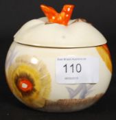 A Clarice Cliff conserve / jam pot complete with the lid bearing stamp to underside.