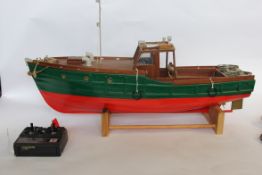 A good radio controlled model boat in wood, complete with working radio gear, Tandy transmitter.