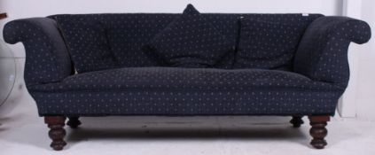 A Victorian Chesterfield double scroll end chaise longue sofa settee being raised on turned legs