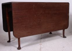 A large 19th century Georgian solid mahogany drop leaf / gate leg dining table raised on tapered,