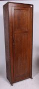 A 1930's Art Deco oak sentry box style hall cupboard being raised on shaped supports with full