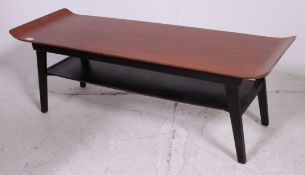 A 1970's retro small teak rectangular ' skateboard top ' coffee table raised on tapered legs.