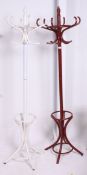 A vintage Thonet style bentwood hat stand being painted white together with another in burgundy (