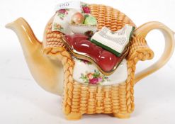 A Royal Albert ' Old Country Roses ' teapot in the form of an armchair with the lid as a cushion,