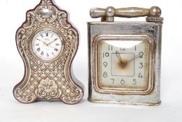 An over sized table lighter lighter mounted with a clock along with another clock having a silver