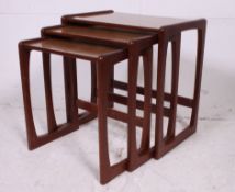 A small retro 1970's teak wood nest of tables in the manner of G-Plan having shaped supports with