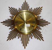 A retro 1970's Junghans gilt metal sunburst wall clock with notation to centre