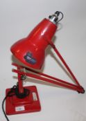 A vintage industrial anglepoise Herbert Terry lamp in red.