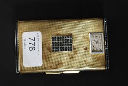 A 1930's Art Deco silver plate cigarette case / compact with inset clock and stone set embellished