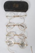 Collection of vintage gold metal framed glasses many different sized and powered lenses