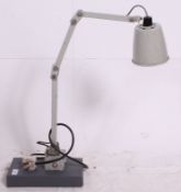 A vintage mid 20th century Industrial anglepoise desk lamp raised on grey painted wooden base with