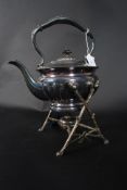A Victorian silverplate spirit kettle raised on a twig style base complete with  the burner having