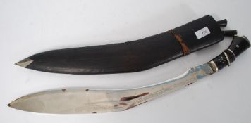 A 20th century large asiatic kukrie knife / machete set within the original black leather scabbard