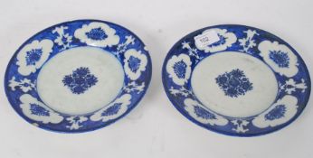 A pair of 19th century Persian Safavid ceramic blue and white plates with central cobalt blue