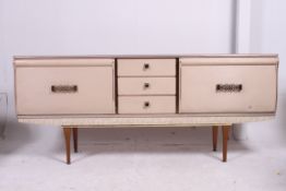 A good 1960's melamine low sideboard dresser having faux marble finish with drop front cabinets and
