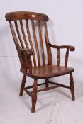 A Victorian beech and elm wood country Windsor armchair.