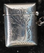 A white metal silver stamped ' sterling ' match vesta with naturalistic engraving.