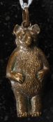 A Victorian brass babies rattle in the form of a bear.