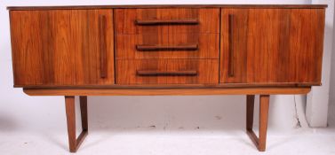 A Vintage sideboard with central bank of three drawers and cupboards to each side on cross branded