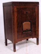 An early oak cased record player having a Bakelite record deck and arm being set under a hinged top.