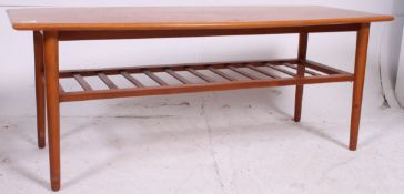 A large vintage retro 70's Teak surf board style coffee table with slatted magazine rack to