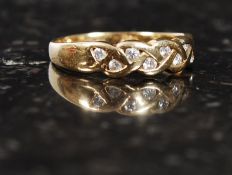 An 18ct gold wedding band, with 16 inset diamonds. Measures: 2.1g size M.