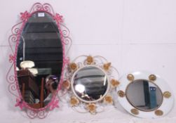 A collection of three vintage / retro wall mirrors having metal scroll work decoration please see
