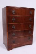 A 1930's Art Deco walnut bow front chest of drawers having the original handles,