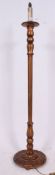 An early 20th century carved and gilded wooden standard lamp