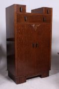 A 1930's Art Deco oak drop centre tallboy chest of drawers.