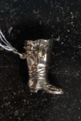 A silver plated vesta in the form of a boot,