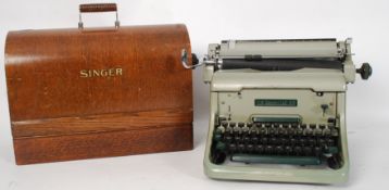 A vintage oak cased Singer sewing machine together with a vintage mid 20th century typewriter